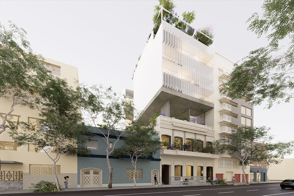 Patio interior de edificio moderno con pasarela, abundante vegetación, luz natural y personas recorriendo un espacio arquitectónico minimalista